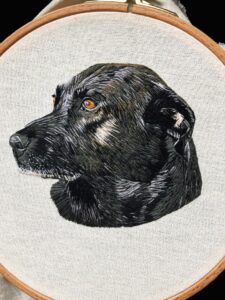 Embroidery of a black Labrador.